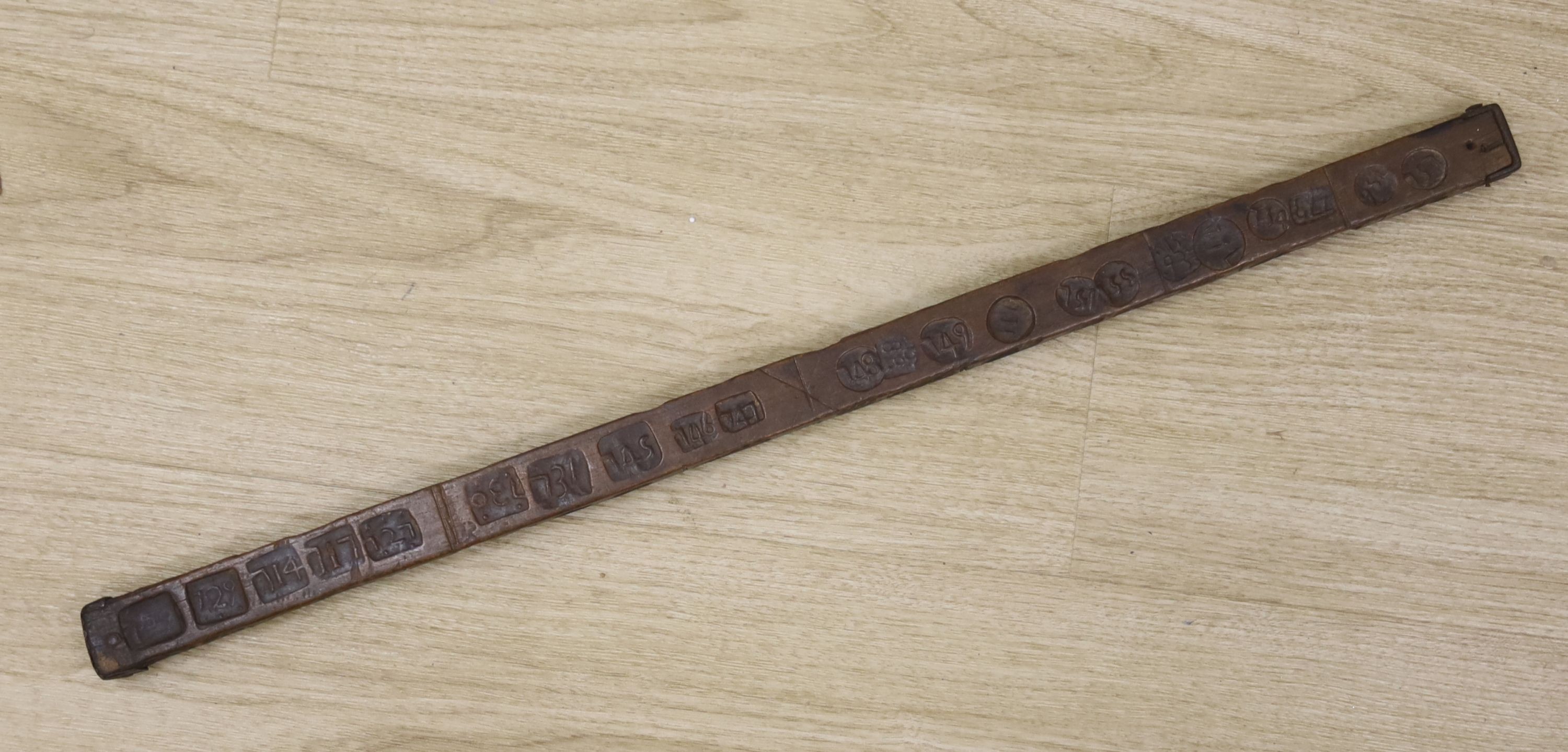 An unusual 18th/19th century rule/gauge or tally stick with impressed numerals, 26cm long